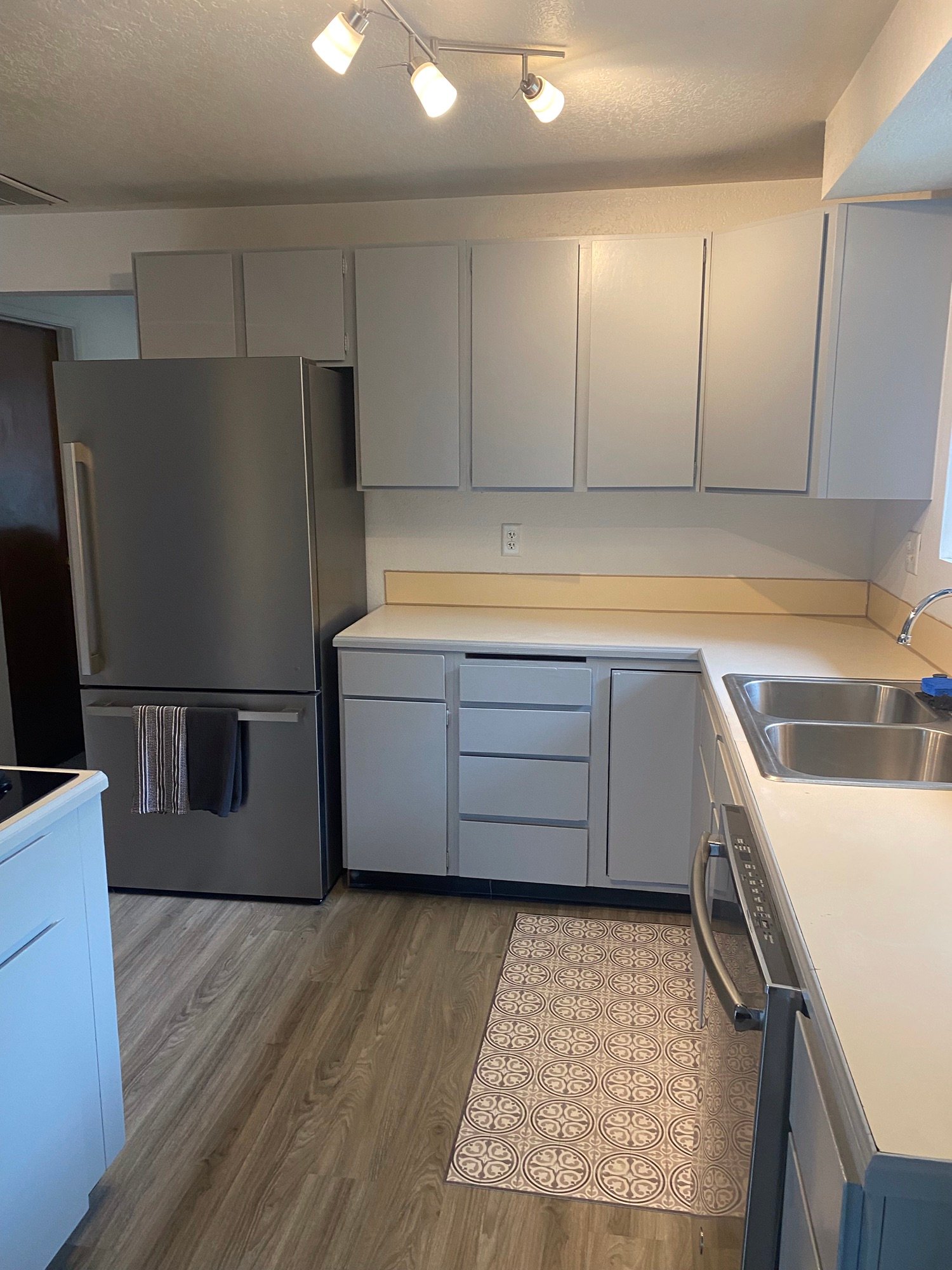 Finished white kitchen and gray flooring